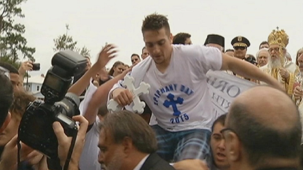 Kosta Pseftelis of Tarpon Springs is carried off to a celebration after retrieving the cross in January 2015. (Spectrum Bay News 9 file)