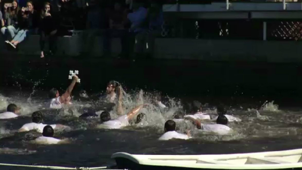 A boy holds up a cross thrown into Spring Bayou by an archbishop Sunday during the annual Epiphany celebration in Tarpon Springs. The event draws thousands annually and is the largest of its kind in the Western Hemisphere. (Spectrum News)