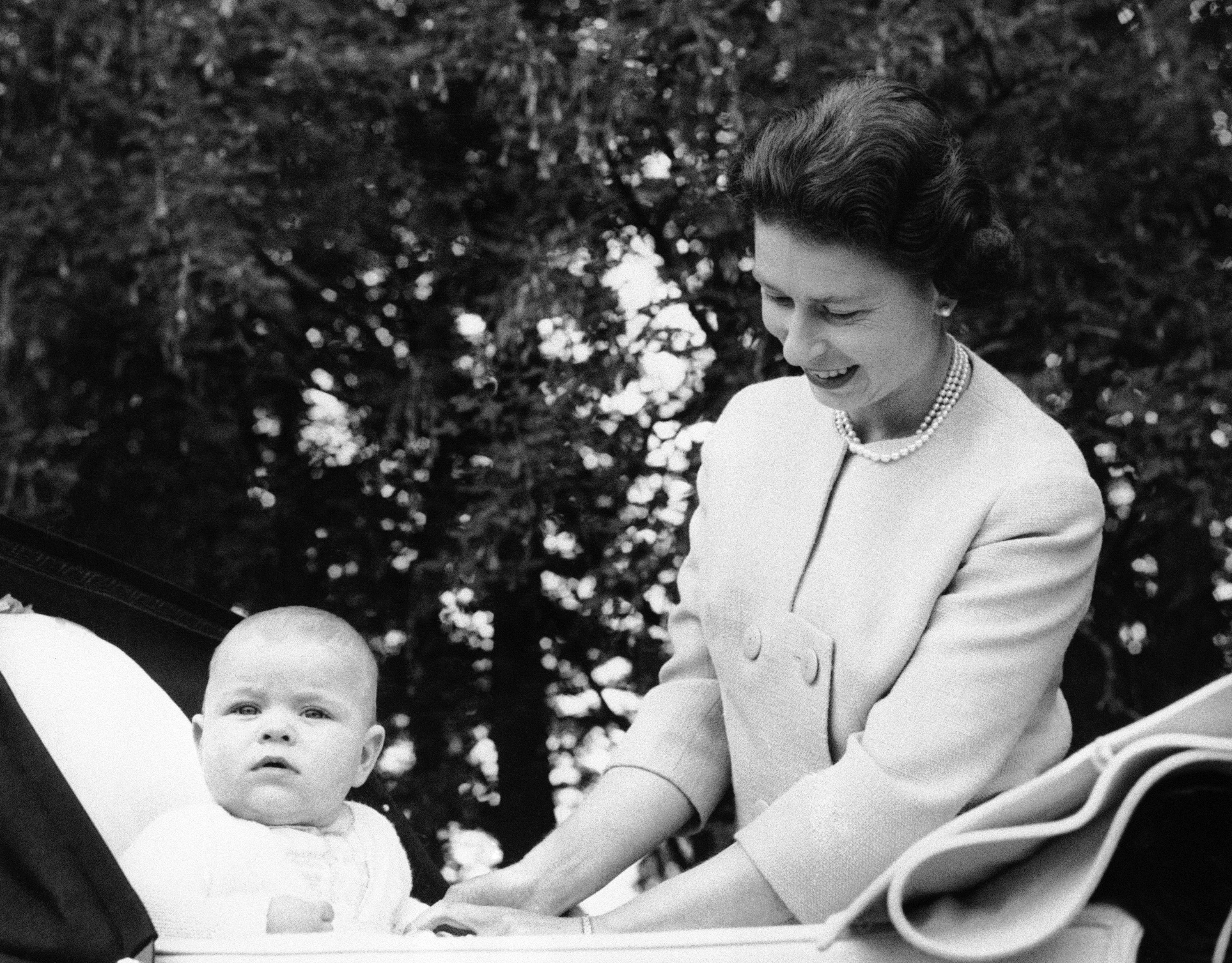 A family watch as Britain's Queen Elizabeth II makes her first televised Christmas broadcast, Dec. 25, 1957. (AP Photo/Sidney Smart)